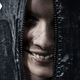A face smiling from inside a body bag